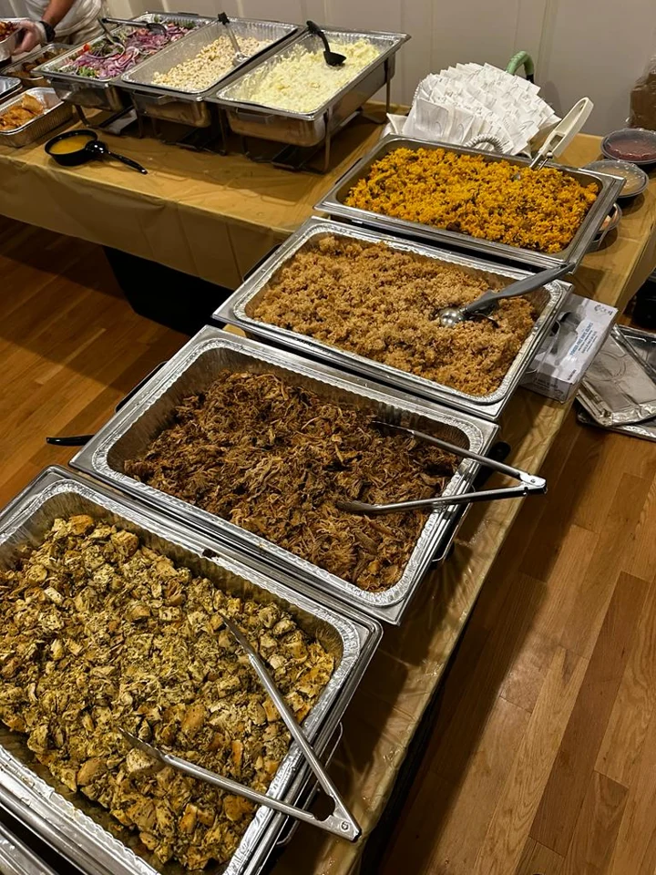 A Kokí catering buffet with trays of Puerto Rican food ready to serve
