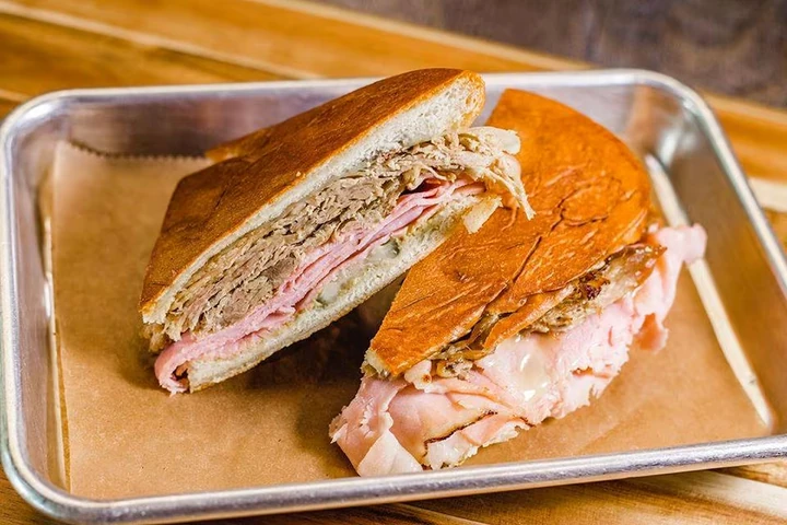 Kokí sandwich halves on a paper-lined metal tray
